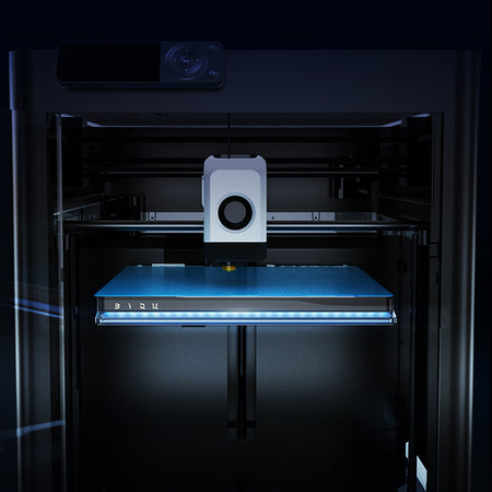 3D printer with a blue platform in a dark setting