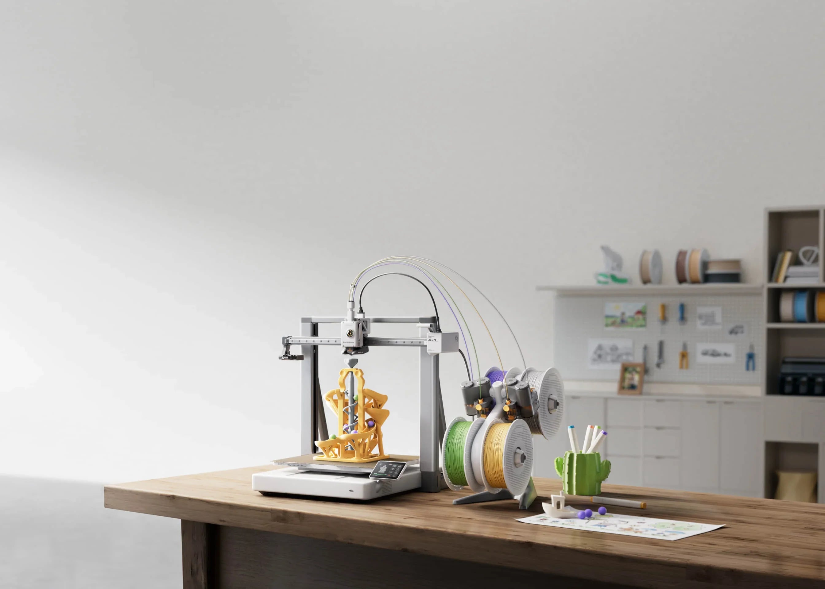 Bambu Lab A2L Series 3D printer with large build volume on a wooden desk in a modern workspace.