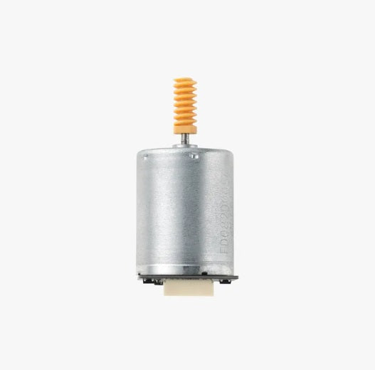 Metallic motor with a yellow and orange component on a white background