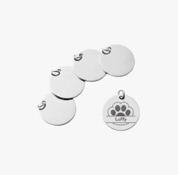 Set of white pet tags with paw prints and engraved text on a white background