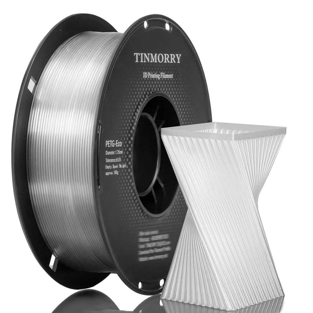 A spool of transparent PETG 6.3mm 3D printing filament next to a white 3D printed geometric object on a clean white background.
