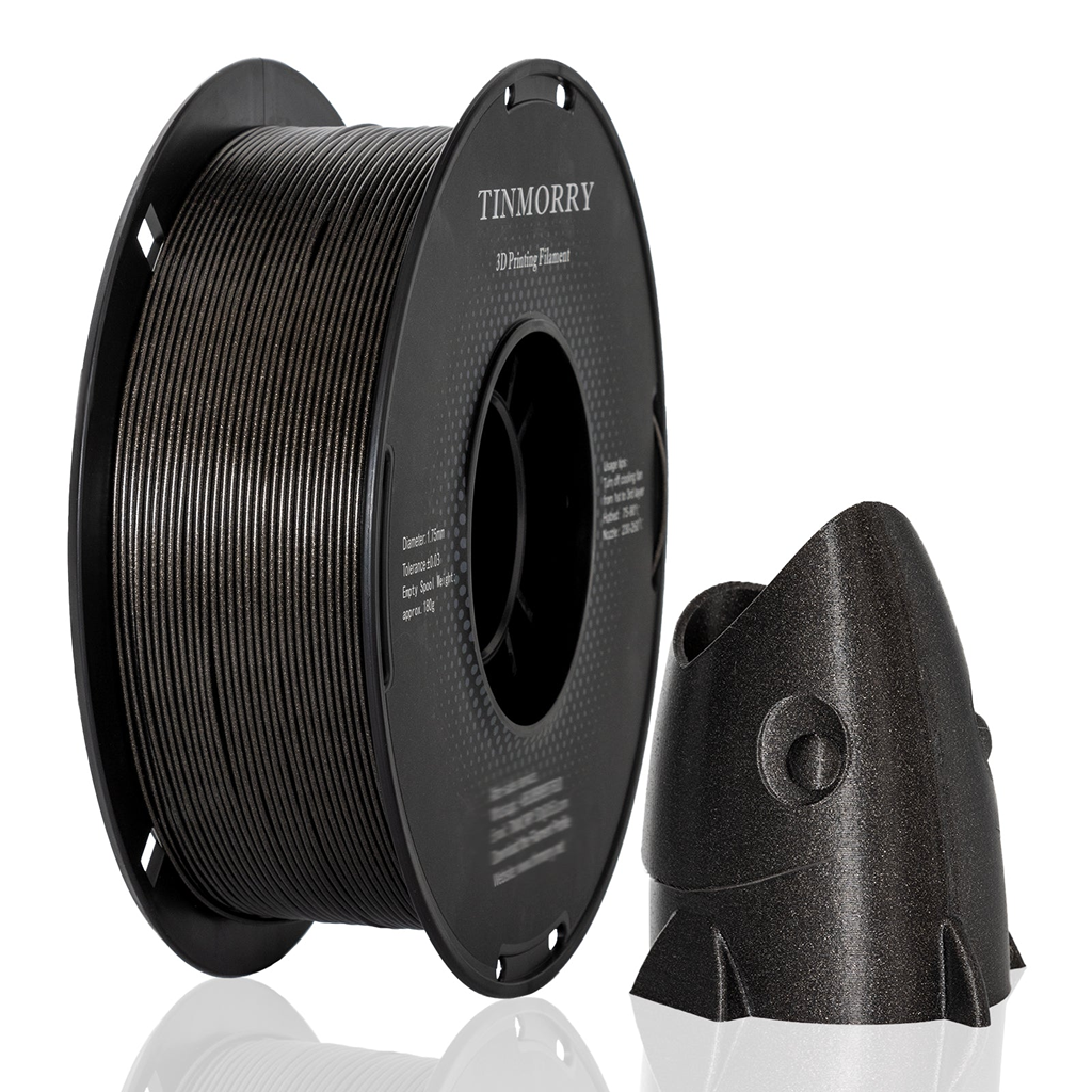 Spool of black 3D printing filament with a printed object on a white background