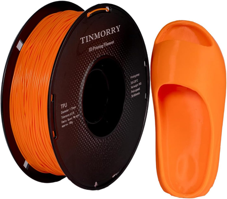 Spool of orange 3D printing filament and a printed object made from it, branded 'TINMORRY'.