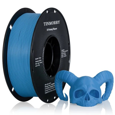 Spool of blue 3D printing filament with a printed skull model on a white background