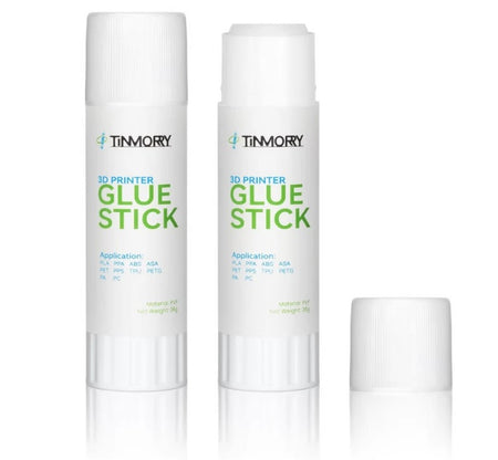 Two white Timmory 3D Printer Glue Sticks with green and blue text, shown on a white background with one cap placed beside them.