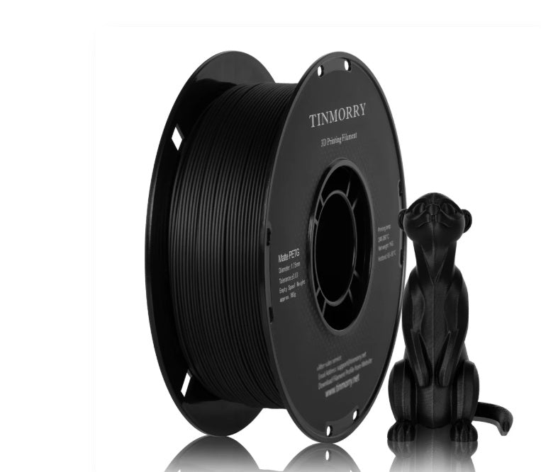 A spool of black 3D printing filament next to a small black 3D-printed cat figurine on a clean white background.