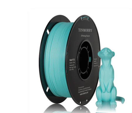 A spool of turquoise 3D printing filament next to a small turquoise 3D-printed cat figurine on a clean white background. The spool features the brand name TINMORRY printed on its black outer rim.