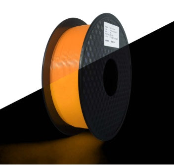 Spool of orange filament on a black and white background