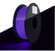 A spools of gLow in the dark purple filament on a black background