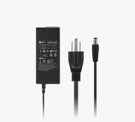 Black power adapter with multiple connectors on a white background