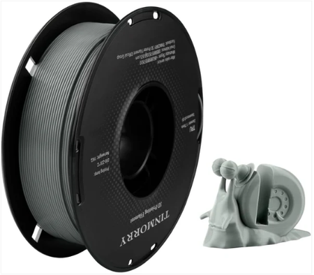 Spool of filament and a 3D printer nozzle on a white background